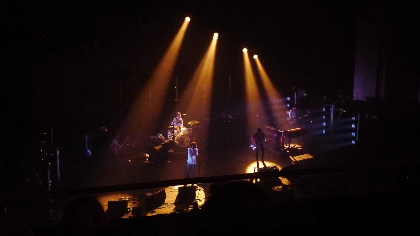 three light beams at the top of a stage