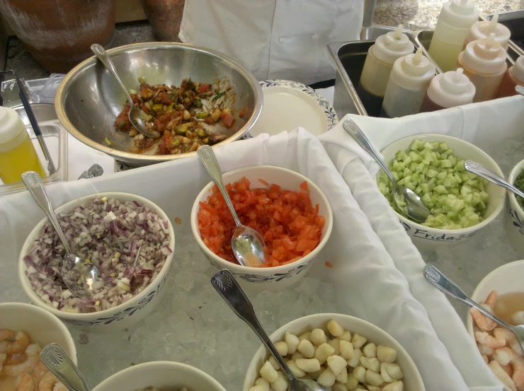 bowls of food are on a table with utensils