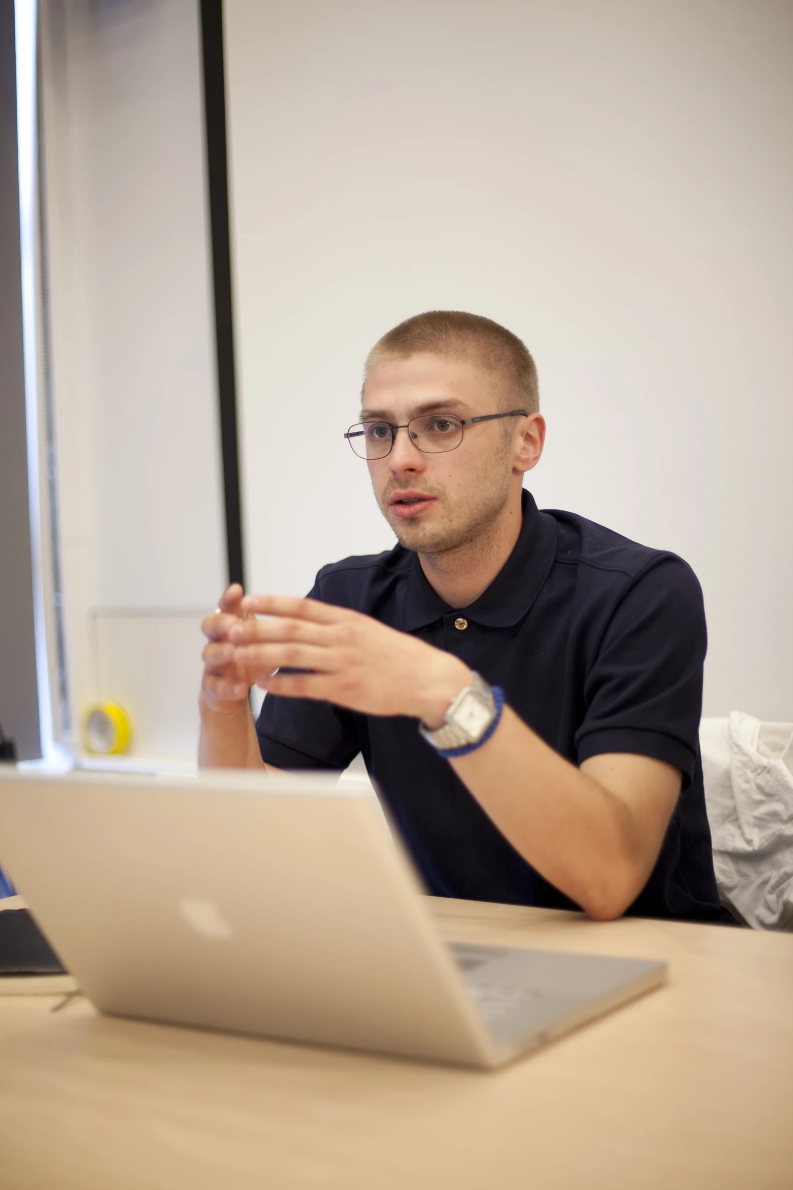 a man sits in front of a computer and gestures