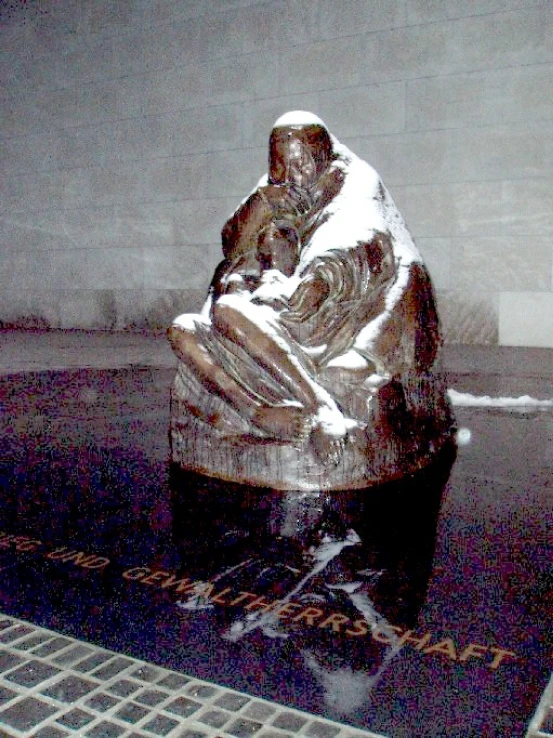 statue of a man holding a child sitting on his lap