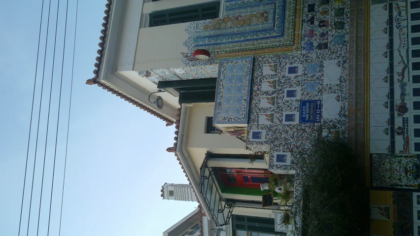 a row of tile houses next to telephone wires and telephone poles