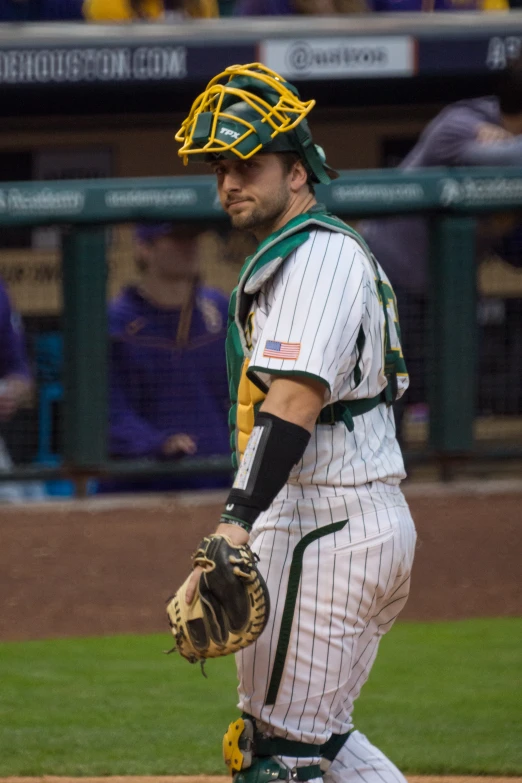 a baseball player walking onto a field while wearing gloves