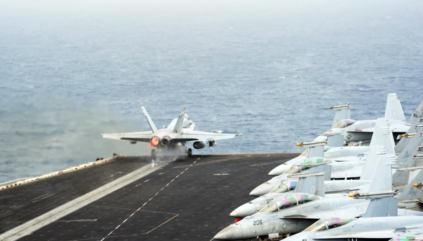 an aircraft carrier on the deck of a large ship