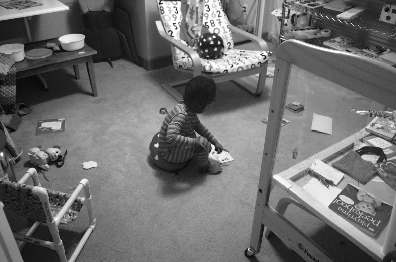 a small child sitting on the floor of a room