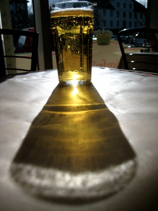 a beverage on a table in front of a window