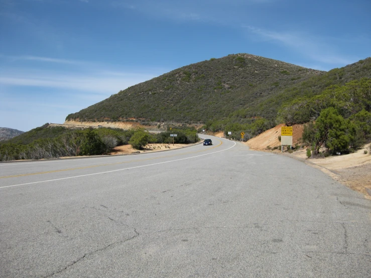 a car driving down a long empty road