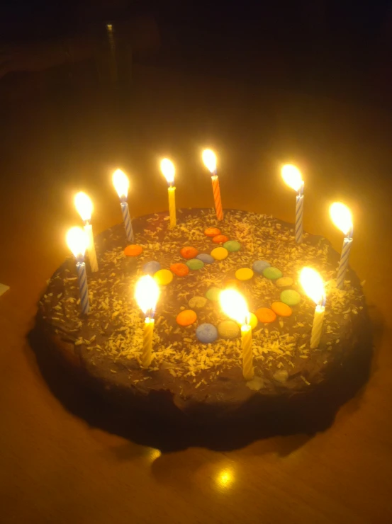 many lit candles that are on a cake