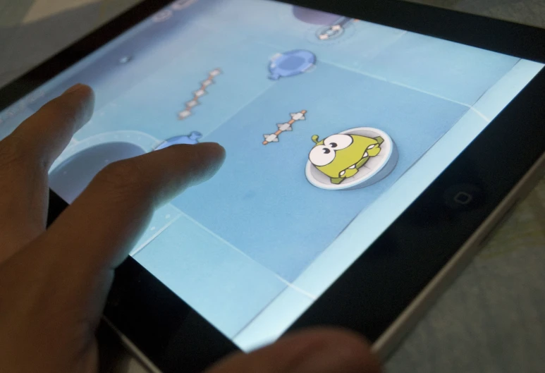 a person using an electronic device with a cartoon on it