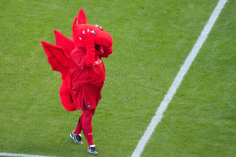 a mascot running with his arms wrapped around