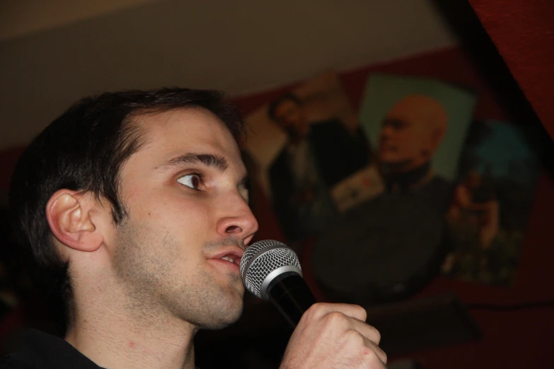 a man with a microphone looks into the distance