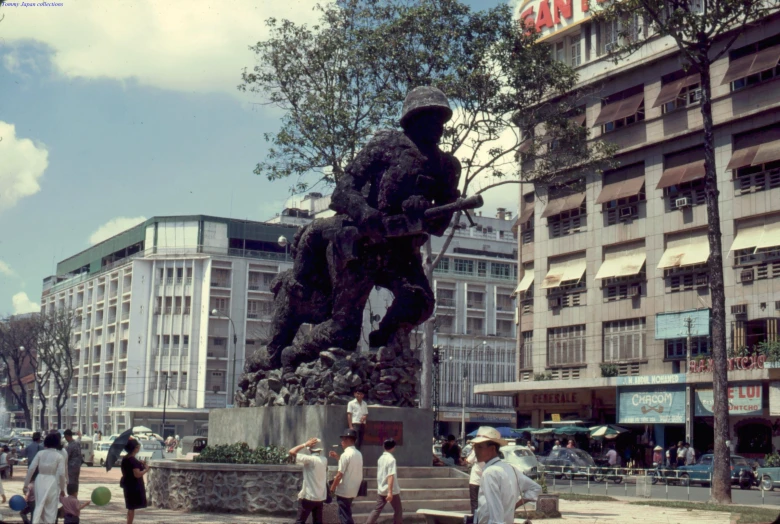 a group of people standing around a statue of a horse and rider