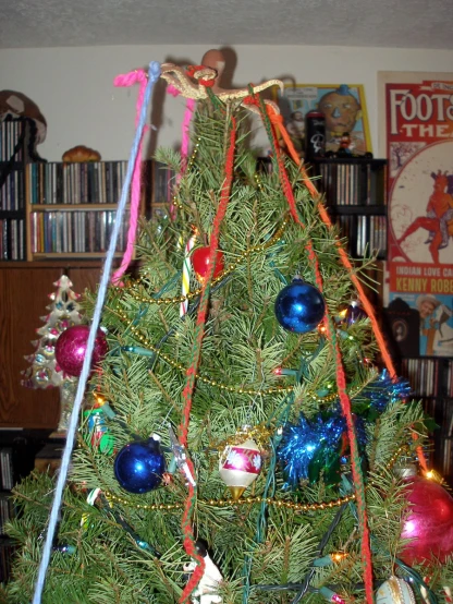 the tree is decorated with festive colored ornaments