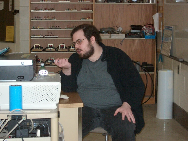 there is a man that has a small laptop on the desk