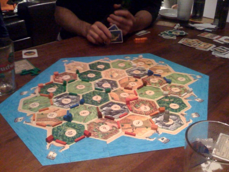 a man playing a game with tiles on a table