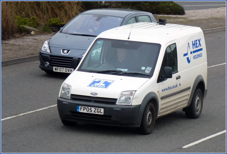 a van is moving in the same direction as a car behind it