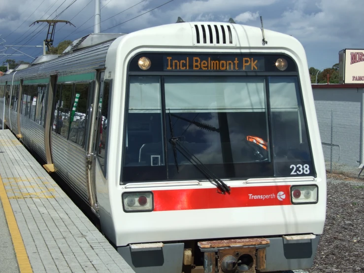 a train is pulling into a station in the day