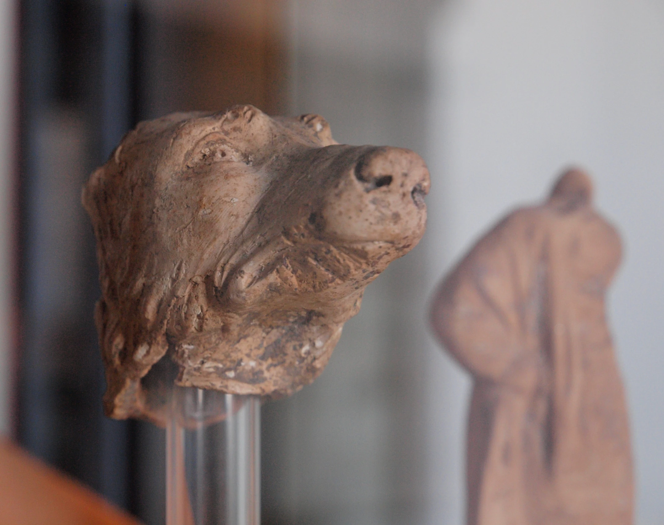 an ancient sculpture of a person in a white room