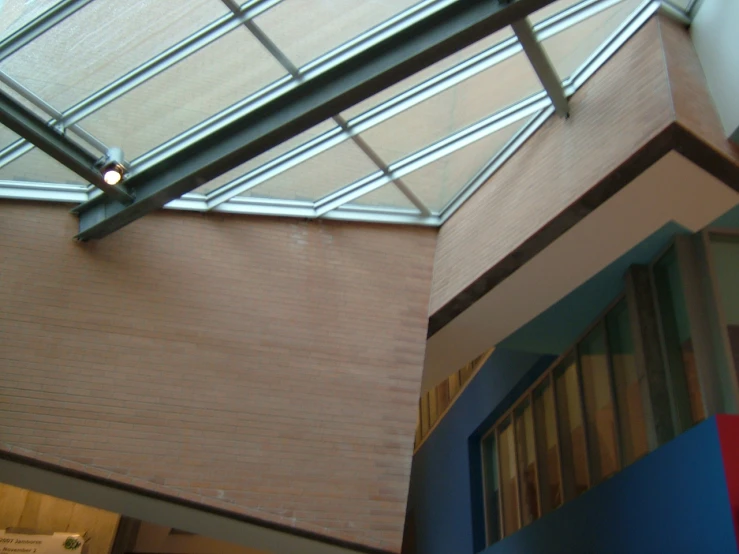 a glass ceiling suspended over an indoor hallway