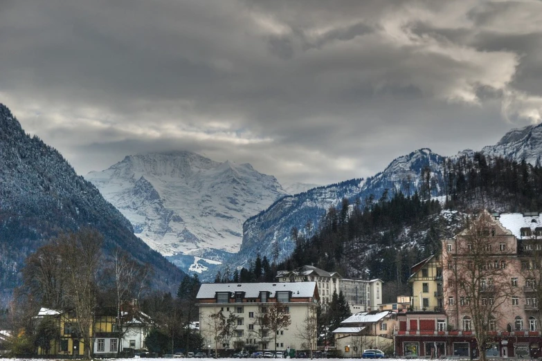 a group of mountains on the horizon in a snowy day