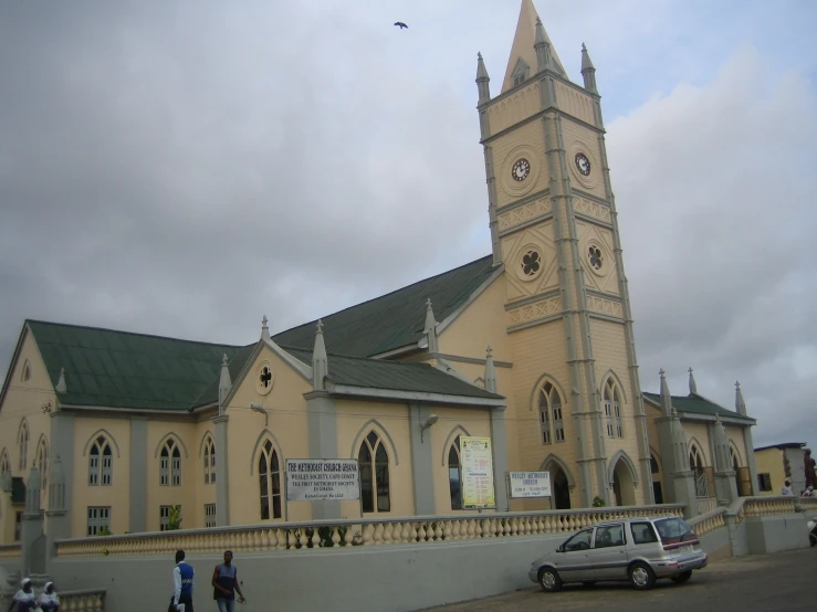 a van parked outside a large church with a tower