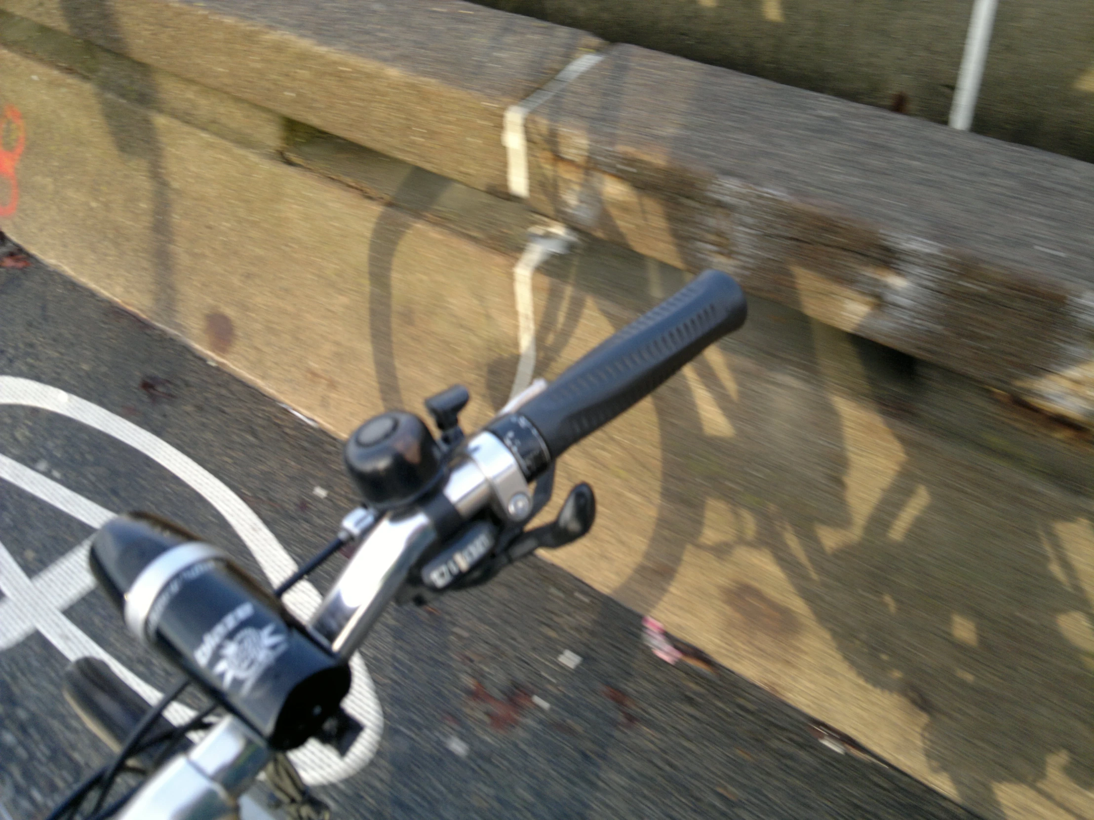 a bicycle handlebar view from directly up on the road