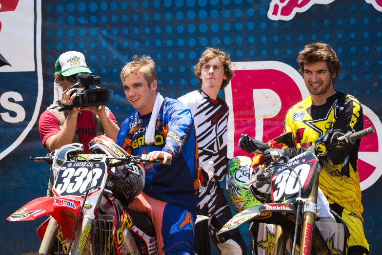 a group of dirt bikes sitting on top of a dirt field