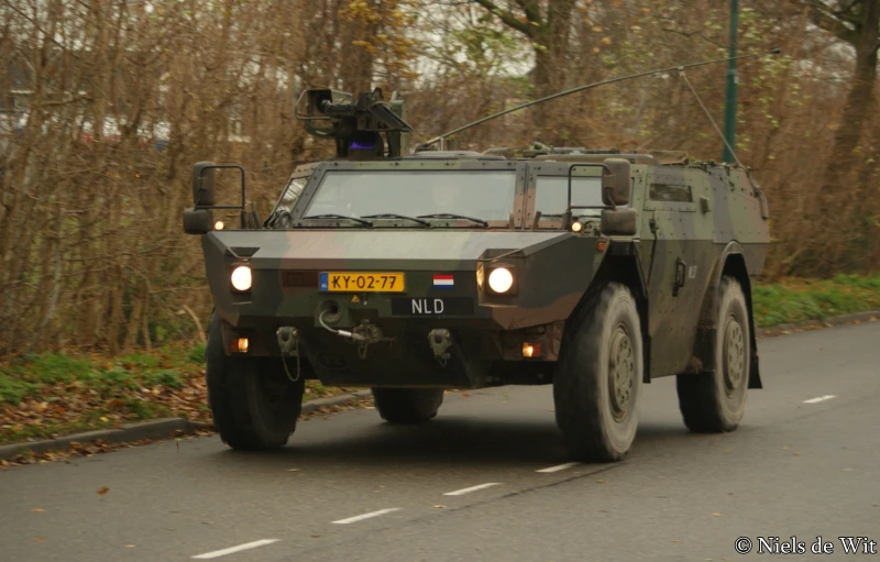 an armored vehicle is driving down a road