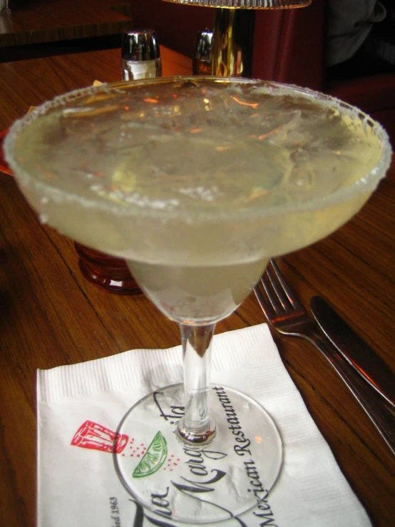 a tall margarita is sitting on a table