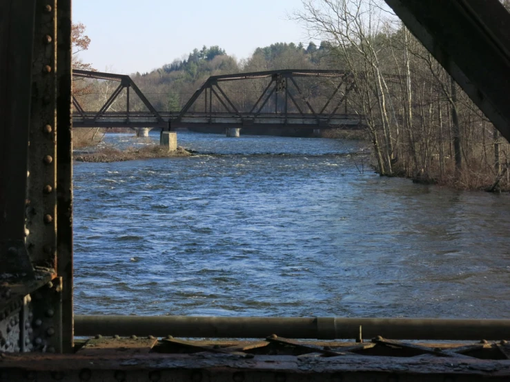 the view from inside a bridge looking out at the water