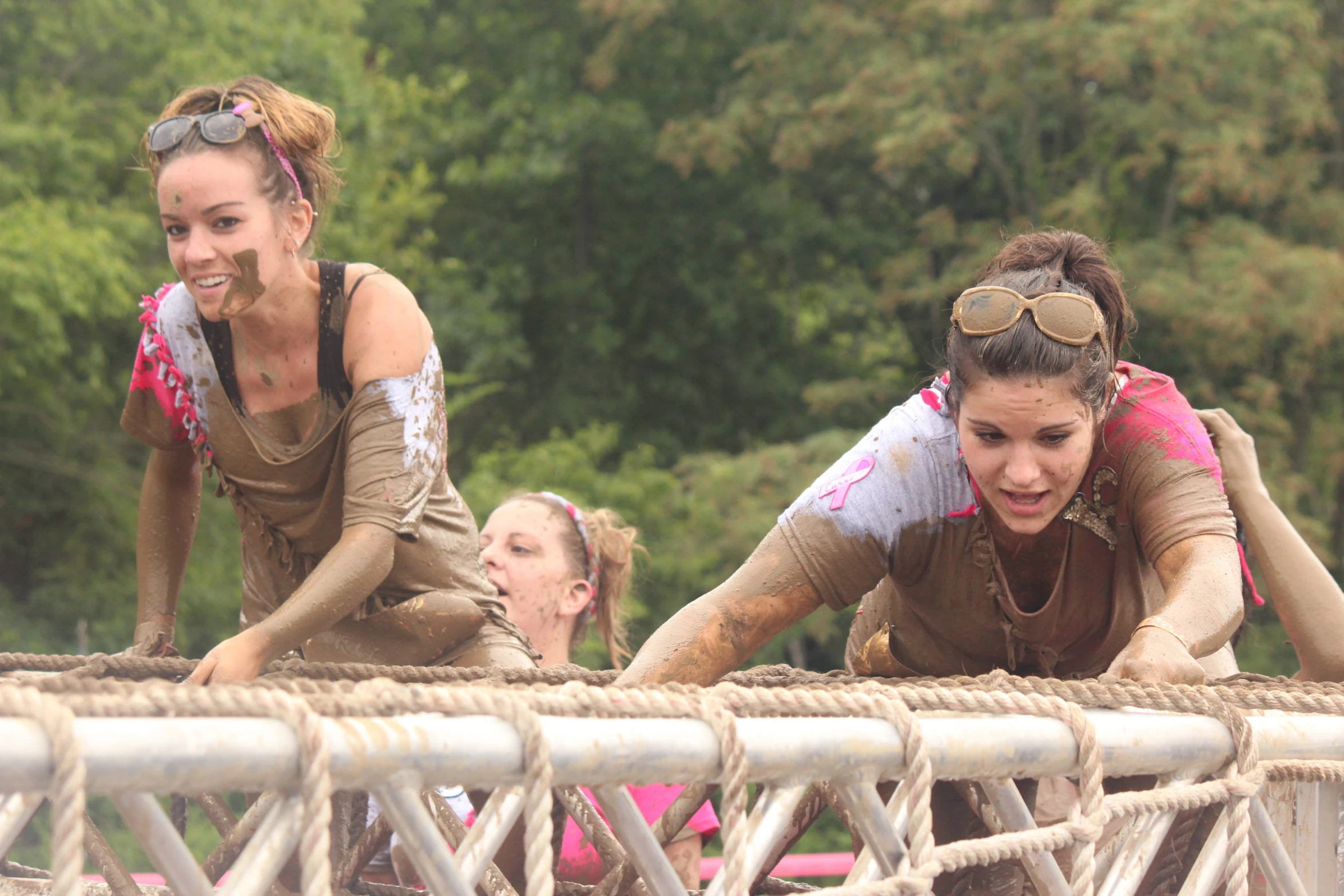 two girls with goggles are walking on a wooden bridge