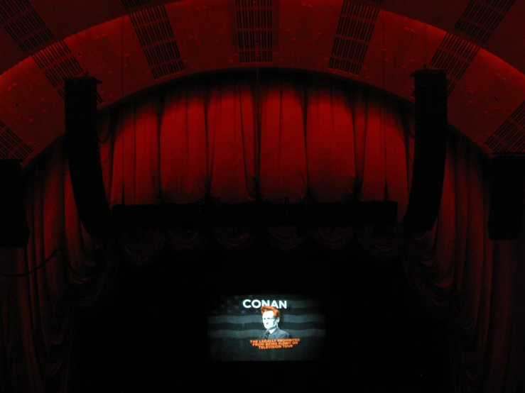 an overhead s of a red lit stage with curtains