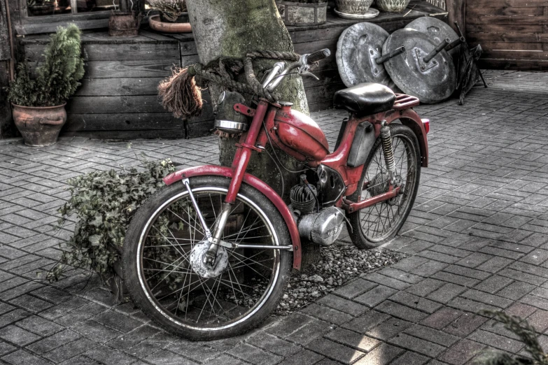 a red motorcycle sitting on a brick walkway
