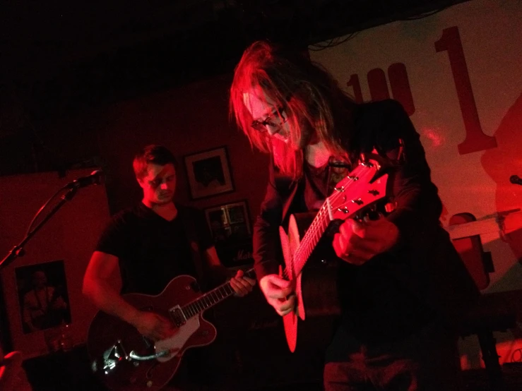 a man playing guitar and singing on stage