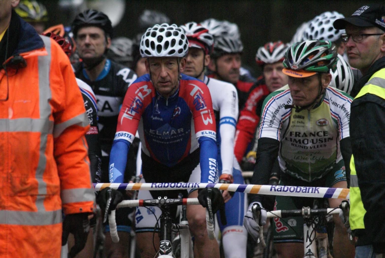 a group of bicyclists riding with many wearing helmets