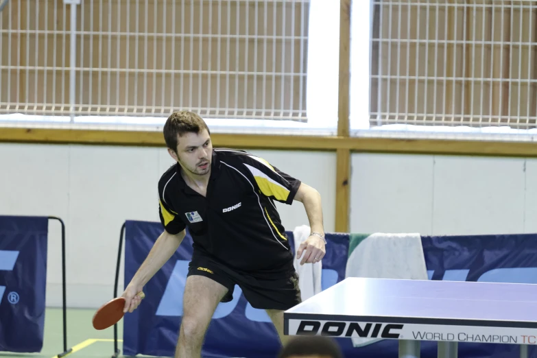 a young man with a racket is playing tennis