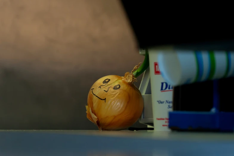 a onion with its face painted on in the middle of some other food