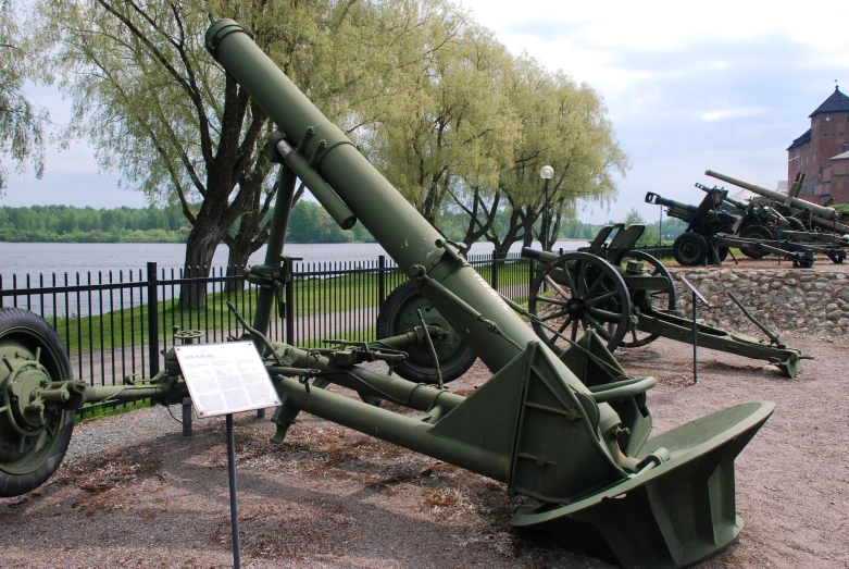 an old cannon on display outside in front of a fence