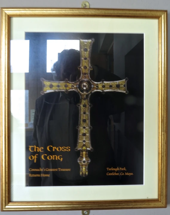 a cross that is on a wall in a frame