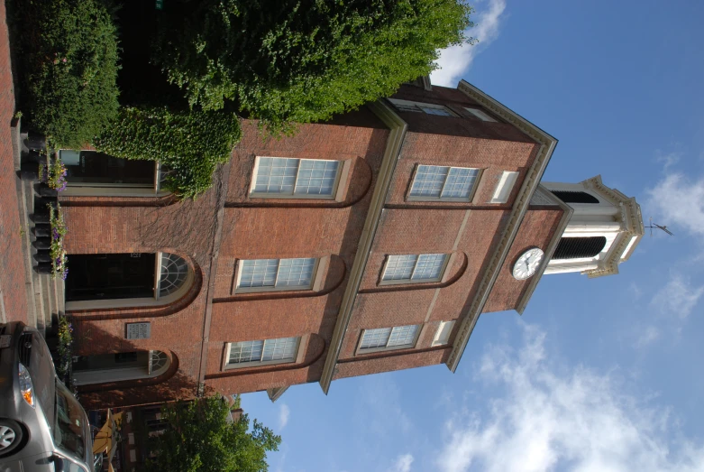 the large red building has a clock tower