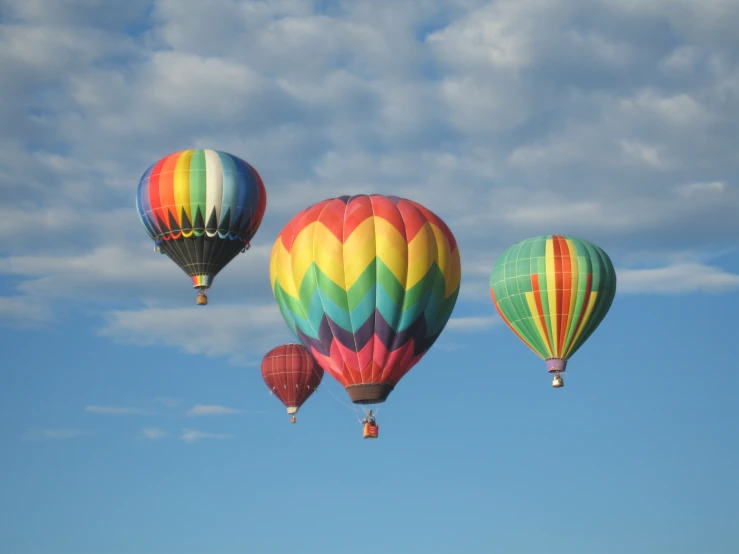 three colorful  air balloons flying in the air