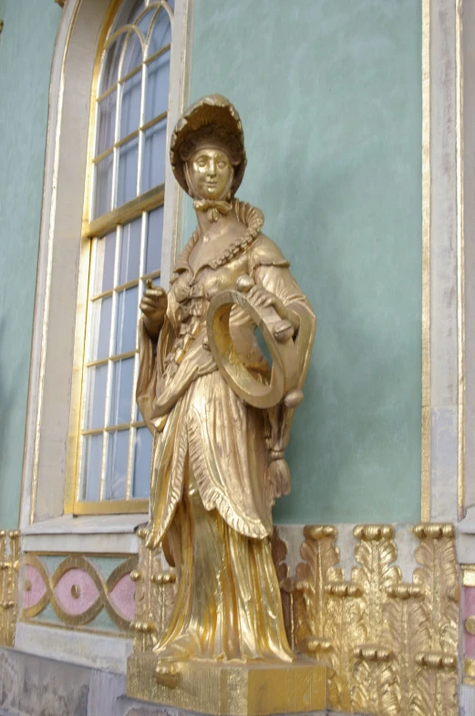 there is a statue with golden accents on the wall