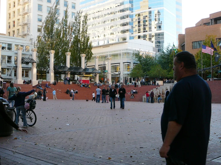 a street scene with some people walking and people riding bikes