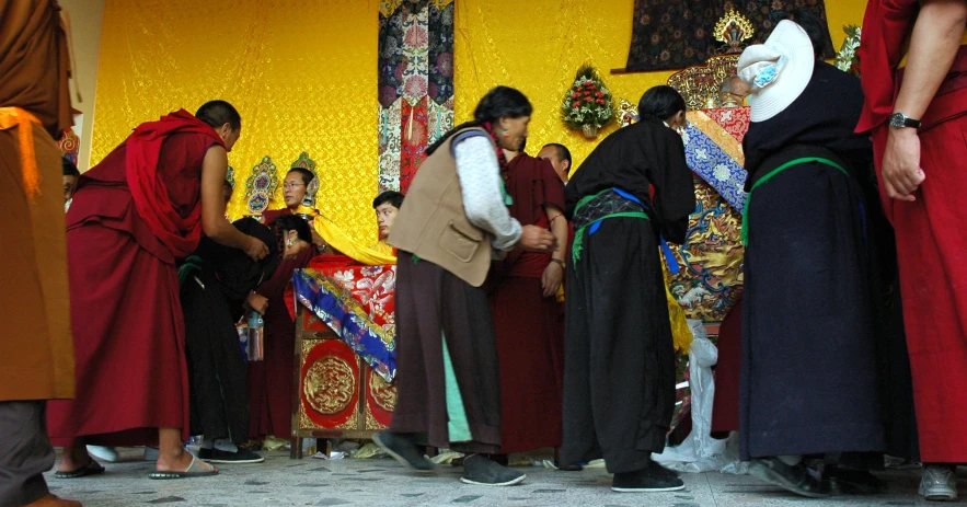 a group of people standing next to each other near a wall