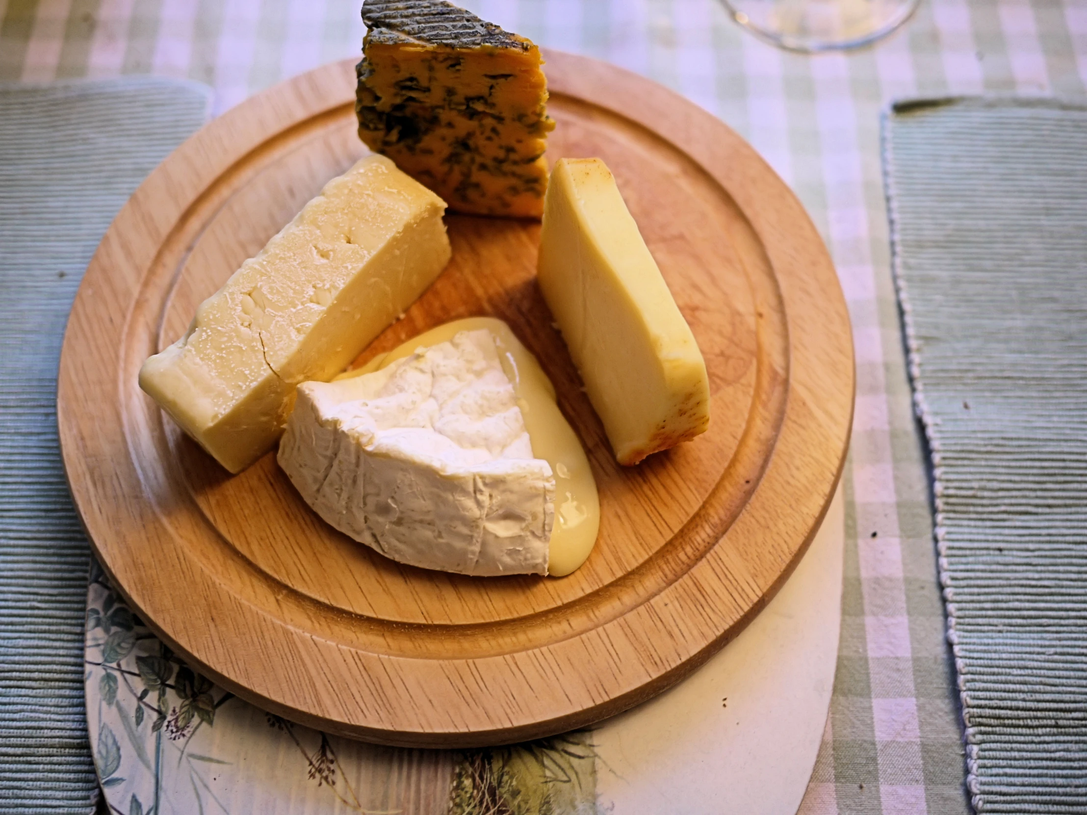 a cheese plate with different types of cheeses on it