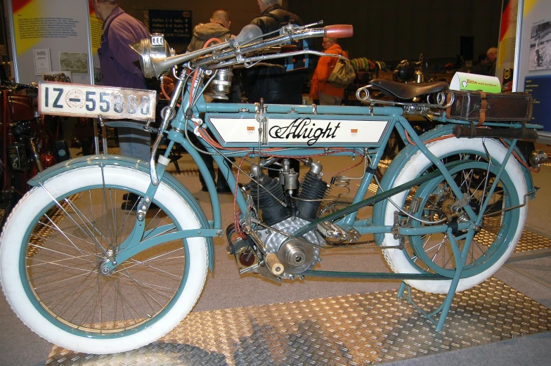 the side view of a motorcycle, with a man in a suit