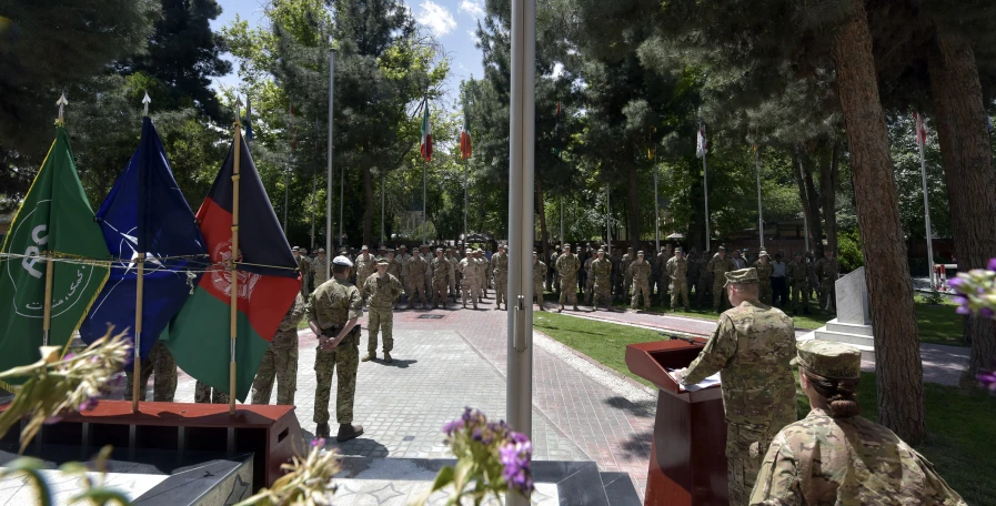 military soldiers stand on the flags at the ceremony