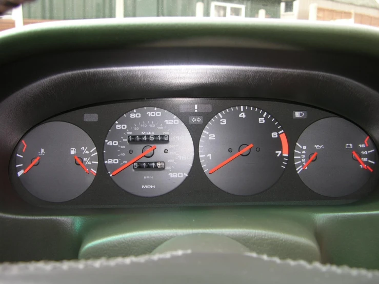 three gauges on an old car dash board