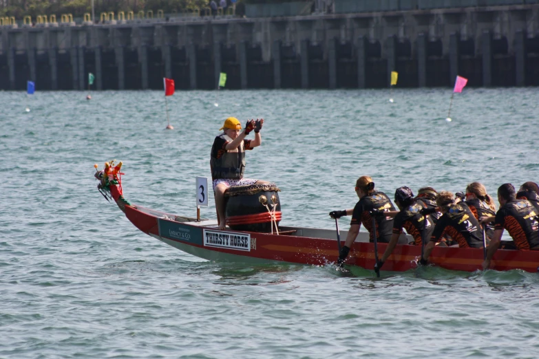 people standing on the end of a boat