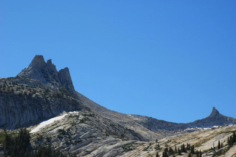 two large rocks on the side of a mountain