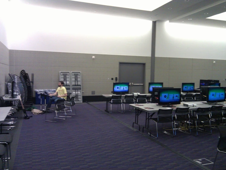 a large room with rows of laptop computers